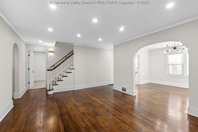 unfurnished living room featuring dark hardwood / wood-style flooring and crown molding