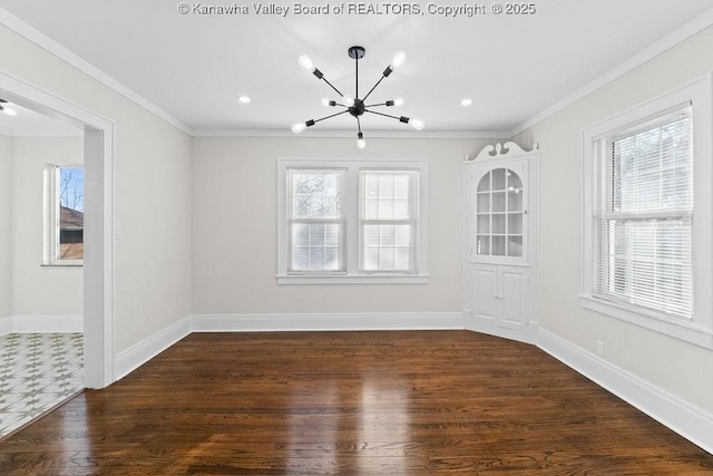 spare room featuring crown molding, dark wood-type flooring, and a chandelier