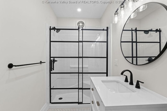 bathroom with an enclosed shower and vanity