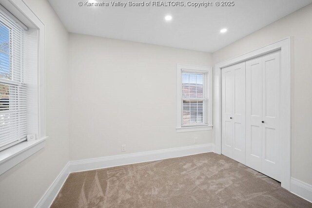 unfurnished bedroom with carpet flooring and a closet