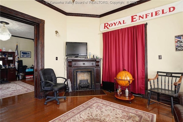 home office with dark wood-type flooring and ornamental molding