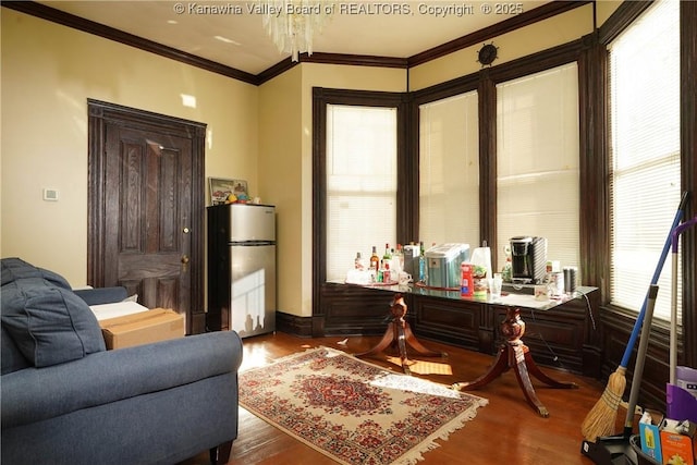 interior space featuring hardwood / wood-style floors and crown molding