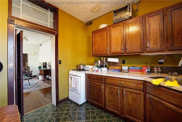 kitchen featuring gas range gas stove and a textured ceiling