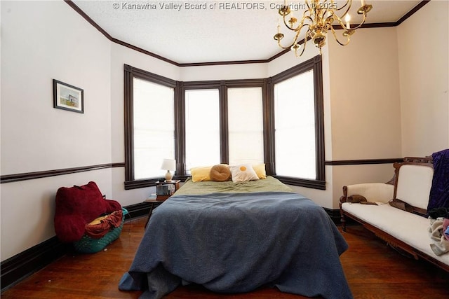 bedroom featuring dark hardwood / wood-style flooring, crown molding, and a chandelier