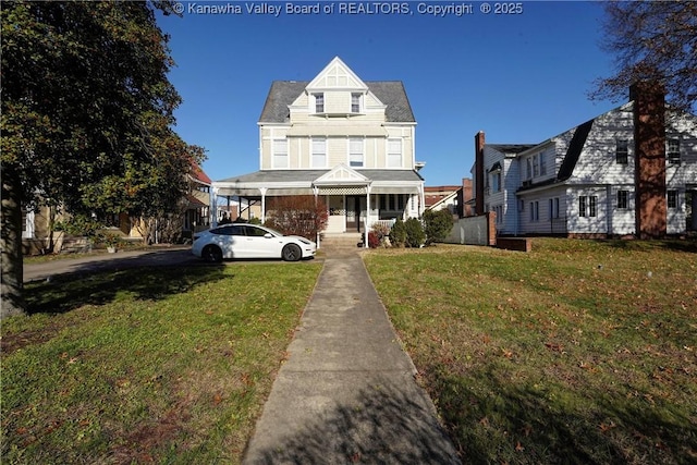 view of front of home with a front yard and covered porch