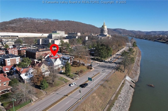 birds eye view of property with a water and mountain view