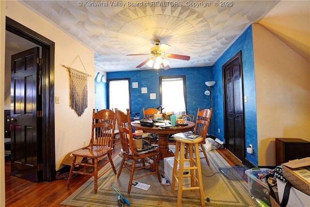 dining space with wood-type flooring and ceiling fan