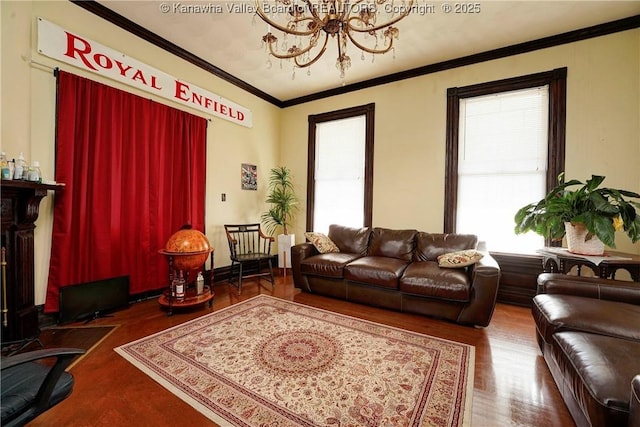 living room with hardwood / wood-style flooring, ornamental molding, and a chandelier