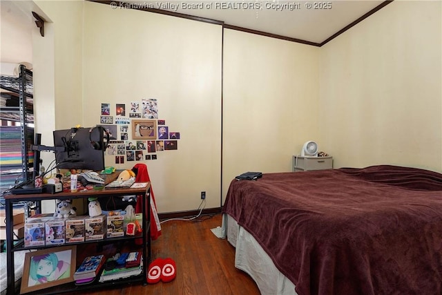 bedroom featuring dark hardwood / wood-style flooring and ornamental molding