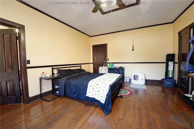 bedroom featuring dark hardwood / wood-style flooring, ornamental molding, and ceiling fan