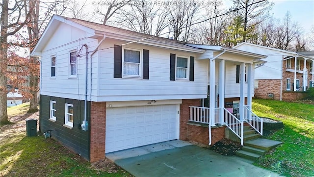 bi-level home with a garage and a front lawn