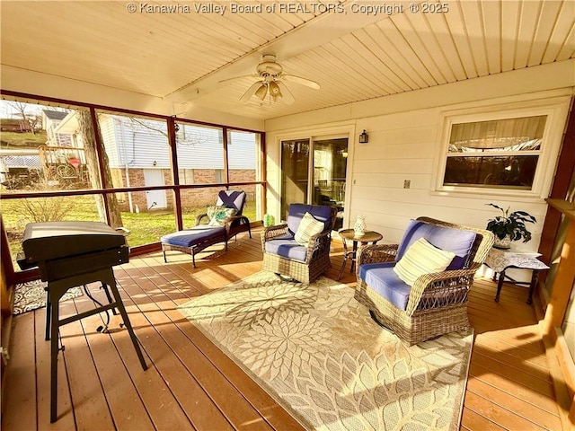 sunroom with wood ceiling, beamed ceiling, and ceiling fan