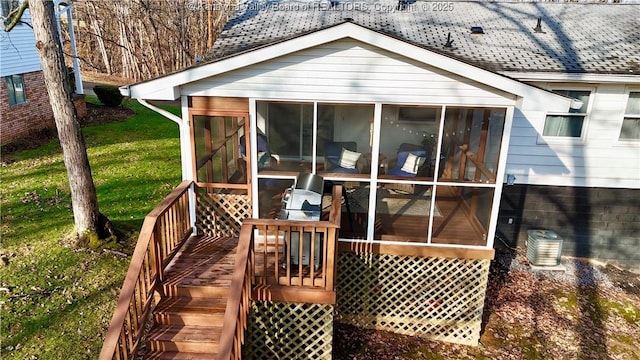 wooden terrace with a lawn, a sunroom, and central air condition unit