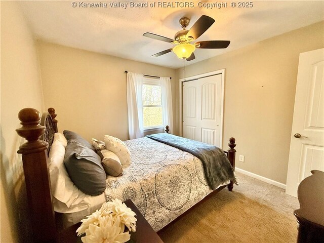 carpeted bedroom featuring ceiling fan and a closet