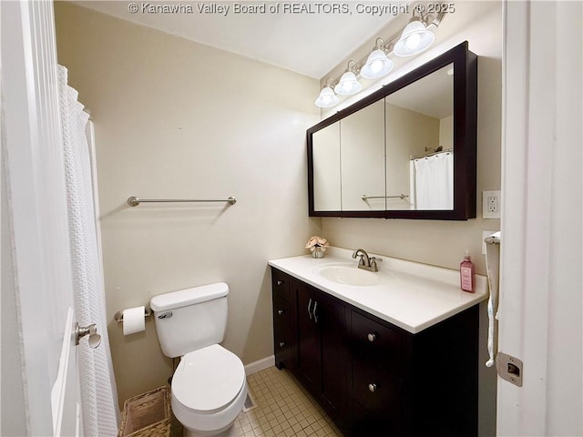 bathroom featuring tile patterned flooring, vanity, and toilet