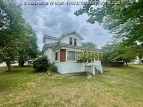 rear view of house with a lawn