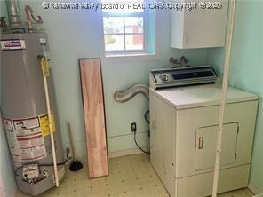 washroom with washer / clothes dryer, gas water heater, and cabinets