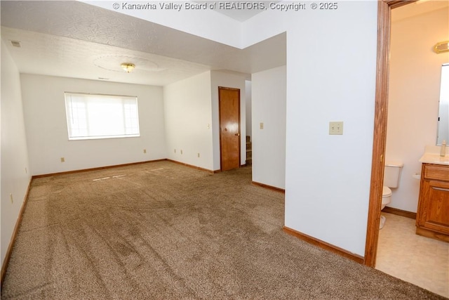 carpeted empty room with a textured ceiling