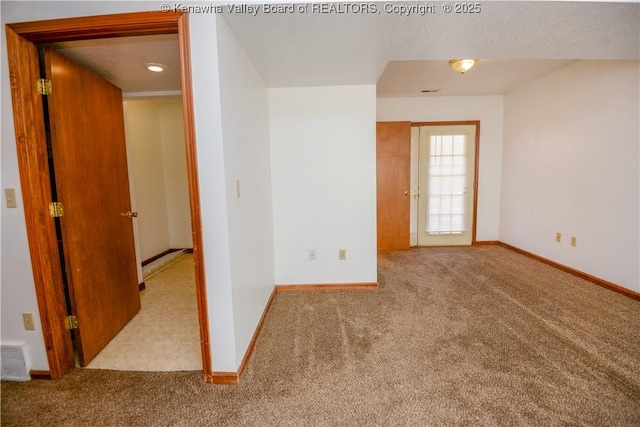 spare room featuring light colored carpet