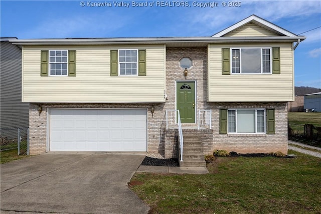 raised ranch with a garage and a front lawn