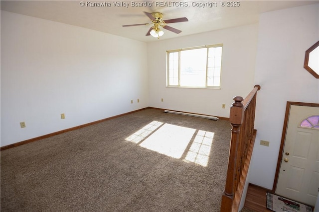 carpeted spare room with a baseboard heating unit and ceiling fan