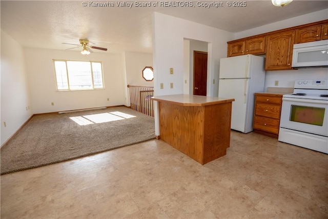 kitchen featuring white appliances, light colored carpet, kitchen peninsula, and ceiling fan