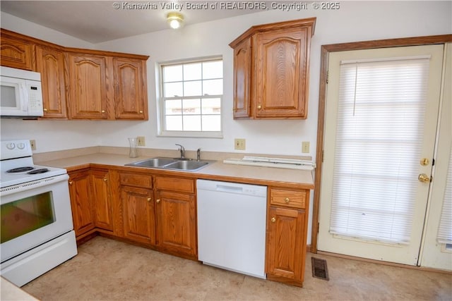 kitchen with sink and white appliances