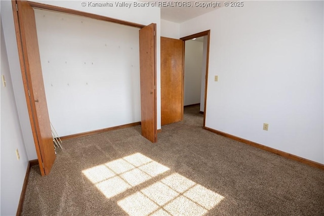 unfurnished bedroom featuring carpet flooring and a closet