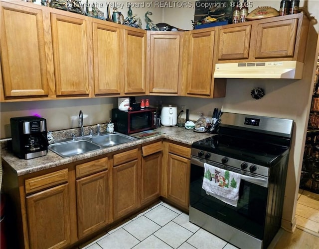 kitchen featuring under cabinet range hood, electric stove, a sink, and light tile patterned flooring