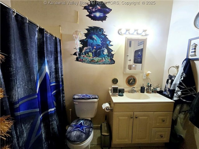 full bath featuring vanity and toilet