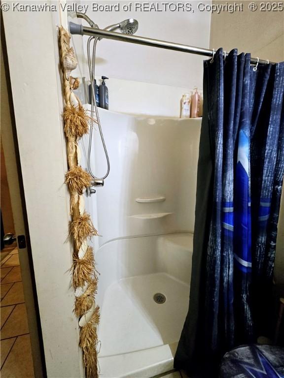 bathroom with tile patterned floors and a shower with shower curtain