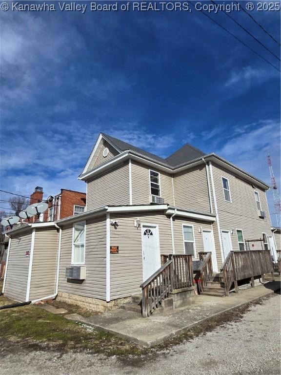 rear view of house featuring cooling unit