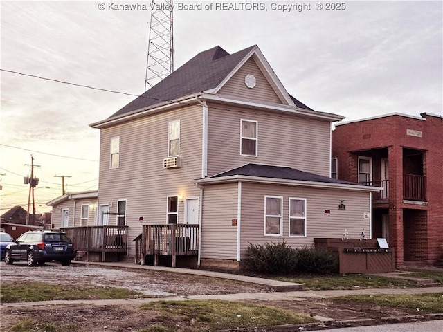 back of property with a deck and cooling unit