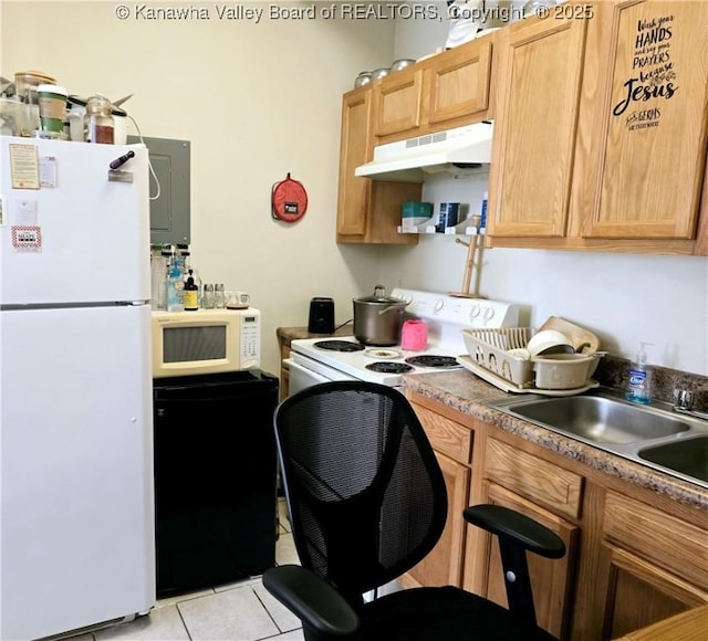 kitchen with a sink, white appliances, light tile patterned flooring, and under cabinet range hood