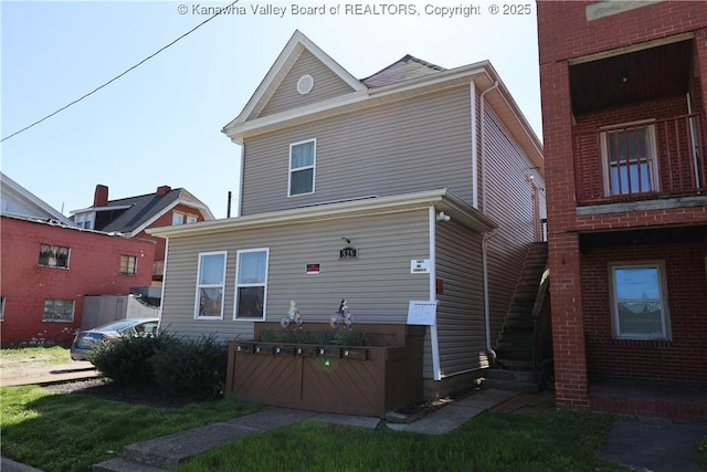 back of property featuring stairs