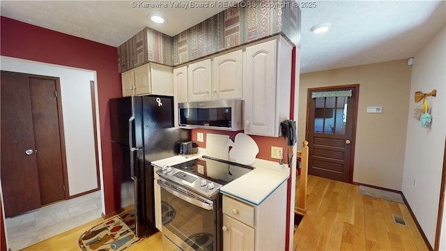 kitchen with stainless steel appliances and light wood-type flooring