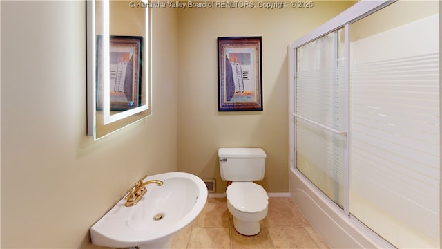 bathroom with toilet, tile patterned flooring, and sink