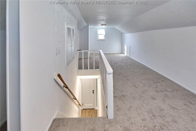 interior space with vaulted ceiling and carpet floors