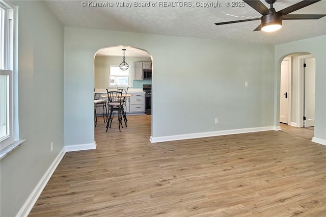 spare room featuring ceiling fan, a textured ceiling, and light hardwood / wood-style floors