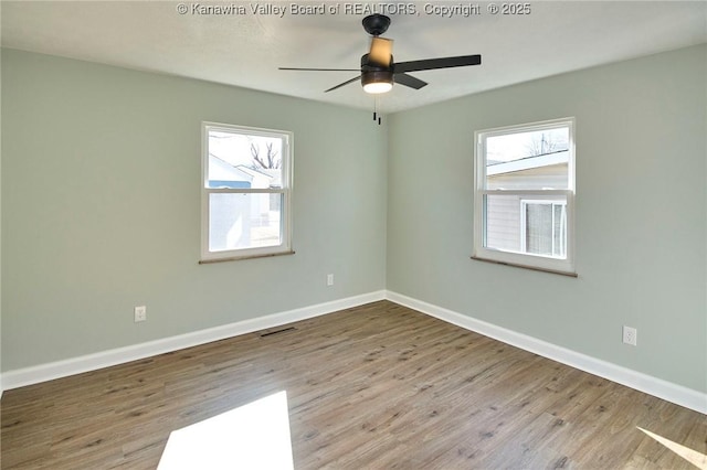 unfurnished room featuring plenty of natural light, light hardwood / wood-style floors, and ceiling fan