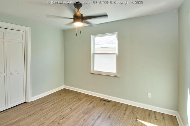 unfurnished bedroom with a closet, ceiling fan, and light wood-type flooring