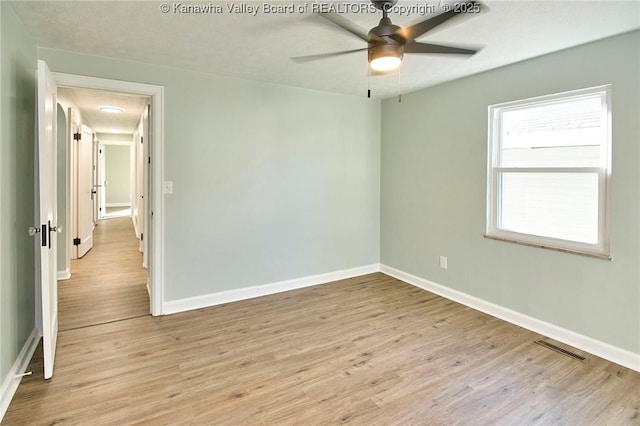 unfurnished room featuring light hardwood / wood-style flooring and ceiling fan