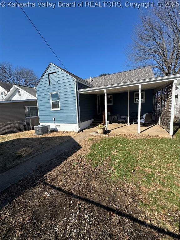 rear view of house with a patio area and a lawn