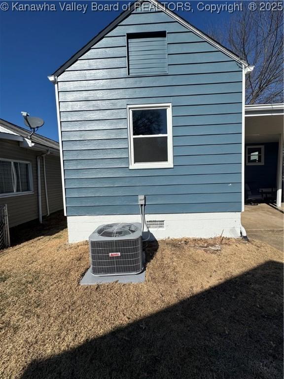 view of side of property with central air condition unit