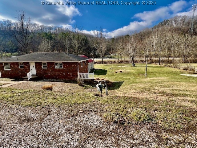 view of side of property with a lawn