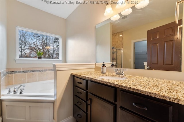 bathroom with a shower with door and vanity