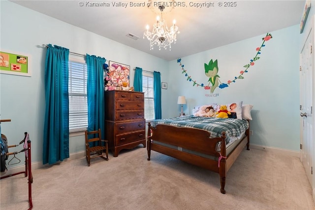 carpeted bedroom with a notable chandelier