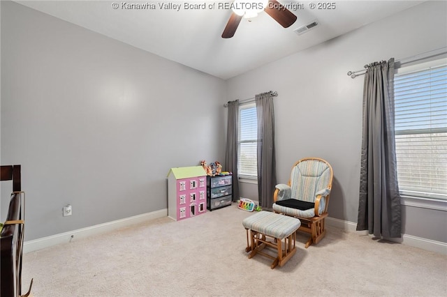 sitting room with ceiling fan and light colored carpet