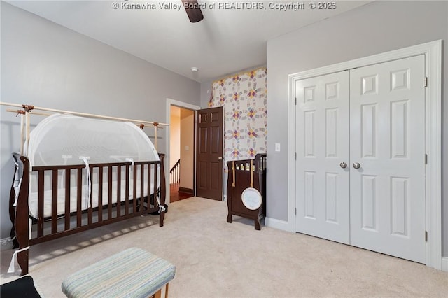 bedroom featuring ceiling fan, a closet, and carpet