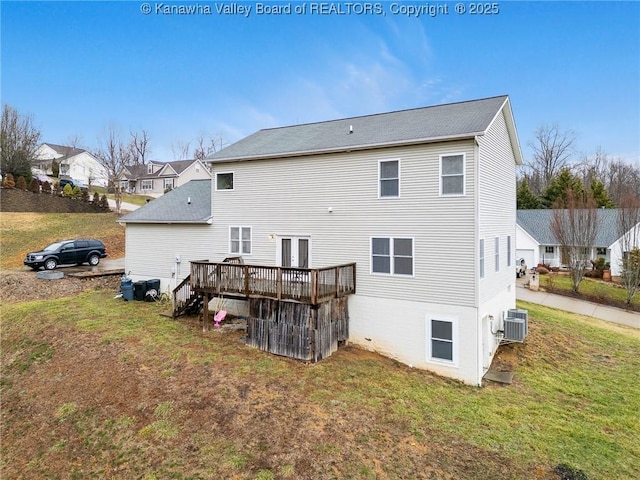 back of property featuring a wooden deck, a yard, and central AC unit